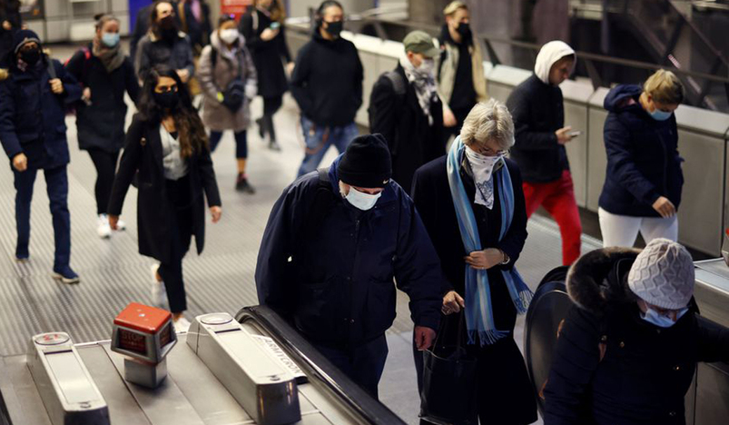 People walk through Westminster Underground station
